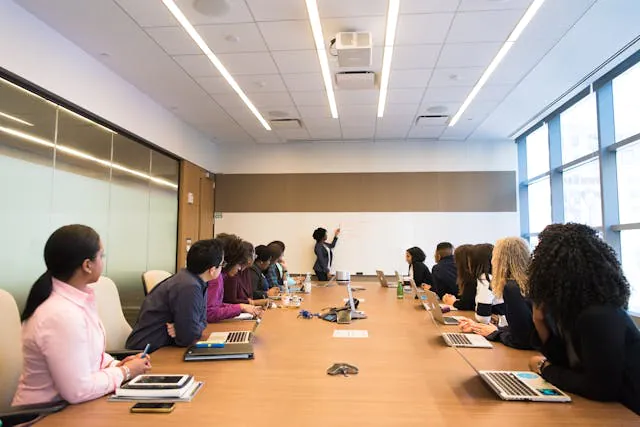a group of people having a business meeting in a conference room